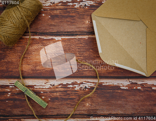 Image of Vintage envelope with pin on wood