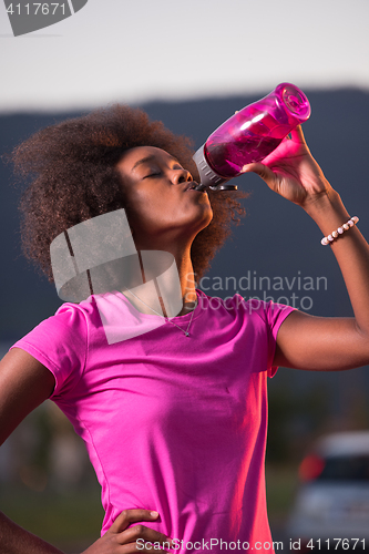 Image of Portrait of a young african american woman running outdoors