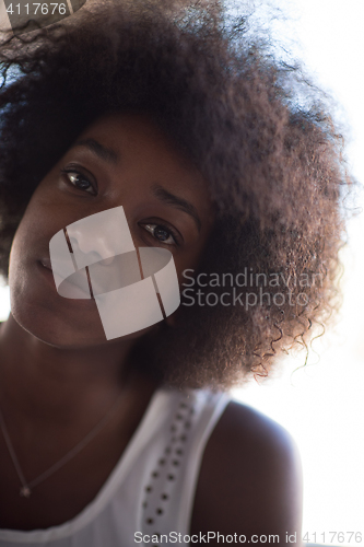 Image of a young African American woman eating pasta