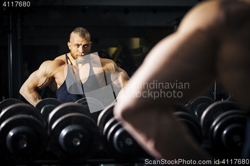 Image of a male bodybuilder in front of a mirror