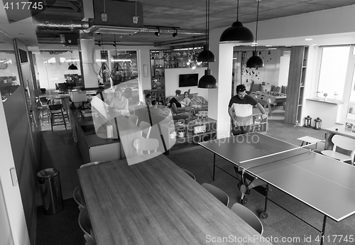 Image of playing ping pong tennis at creative office space