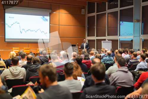 Image of Business speaker giving a talk in conference hall.