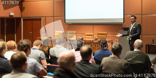 Image of Business speaker giving a talk in conference hall.