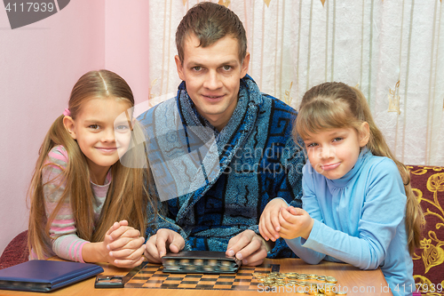 Image of Pope shows children his collection of coins, all together looked in the frame