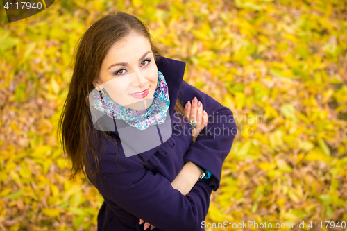 Image of Top view of a beautiful girl against the backdrop of autumn foliage