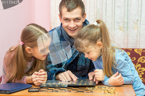 Image of Pope shows the children collection of coins and smiling looked into the frame