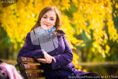 Image of She sat down on the bench and looked at the frame