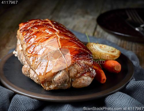 Image of roasted pork on wooden table