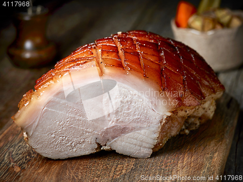 Image of roasted pork on wooden table