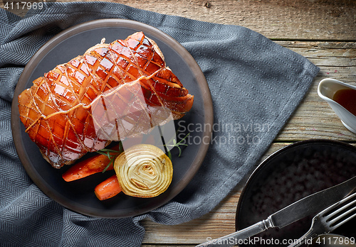 Image of roasted pork on wooden table