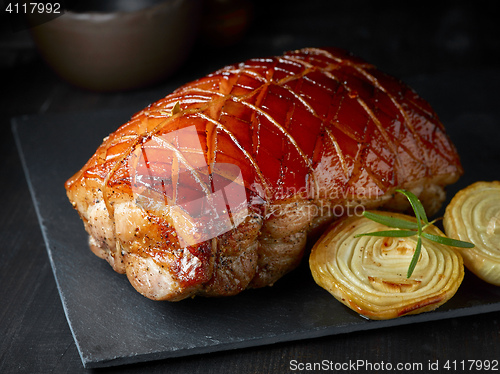Image of roasted pork on black stone plate