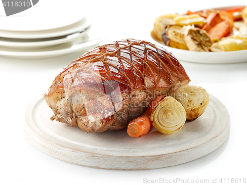 Image of roasted pork on wooden cutting board