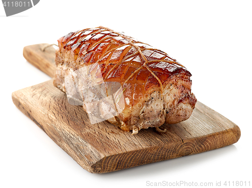 Image of roasted pork on wooden cutting board