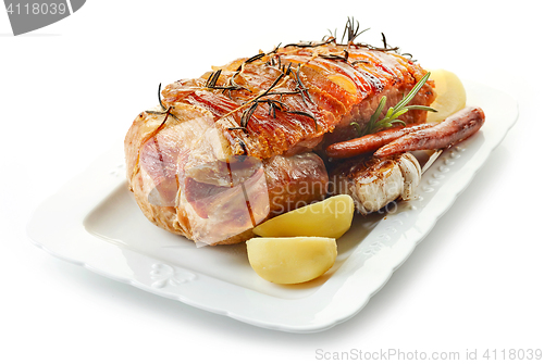 Image of roasted pork and vegetables on white plate