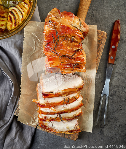 Image of roasted pork on wooden cutting board