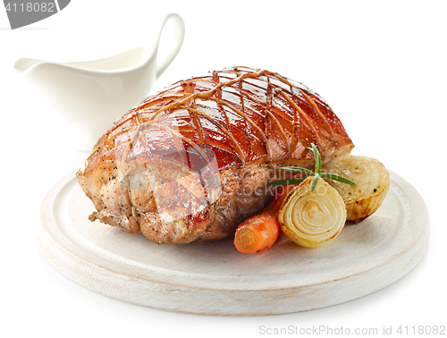 Image of roasted pork on wooden cutting board