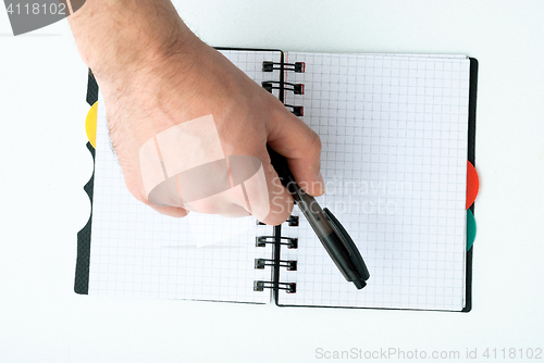 Image of Hand writing on empty notepad