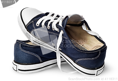 Image of One pair of dark blue sports shoes on one another