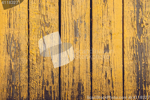 Image of Yellow wooden planks with peeling paint