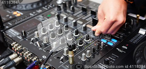 Image of Dj mixes the track in the nightclub at party