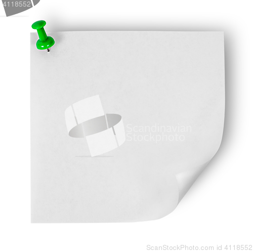 Image of White sticker with the wrapped up corner pinned green office pin