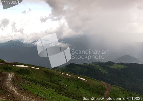 Image of The mountainous landscape of the slopes covered by forest.