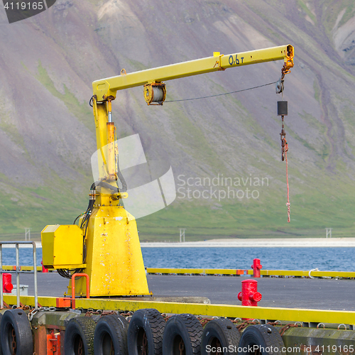 Image of Fishing crane in small seaside Iceland town harbor