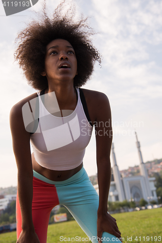 Image of Portrait of sporty young african american woman running outdoors