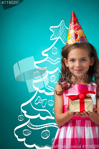 Image of The cute cheerful little girl on blue background