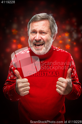 Image of Elderly man showing ok sigh on a red background