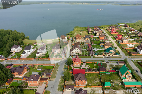 Image of Aerial view onto private houses on bank of lake