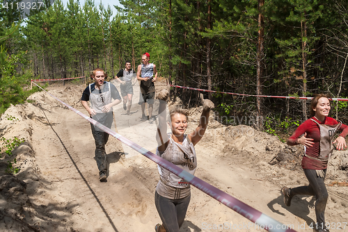 Image of Women run between stages in extrim race.Tyumen