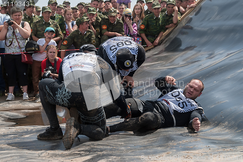 Image of Men give first aid to companion on race. Tyumen