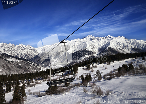 Image of Chair-lift at ski resort and snow winter mountains at nice sun d