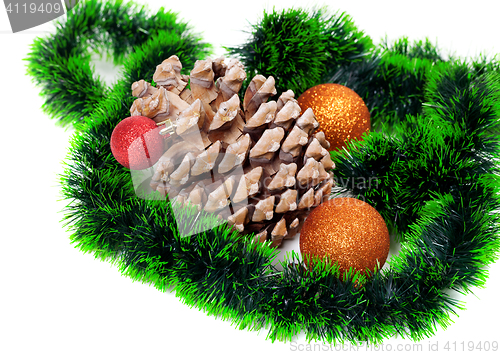 Image of Big pine cone, green Christmas tinsel and Christmas-tree balls