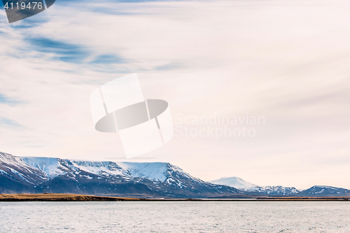 Image of Snow covered mountains in the sea