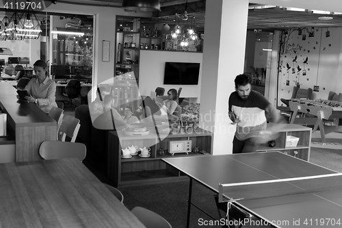 Image of playing ping pong tennis at creative office space