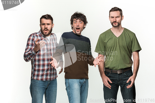 Image of The three men are smiling, looking at camera