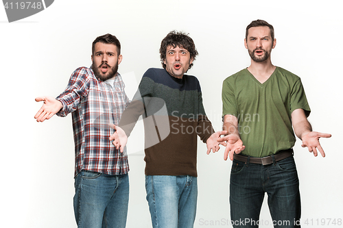 Image of The three men are smiling, looking at camera