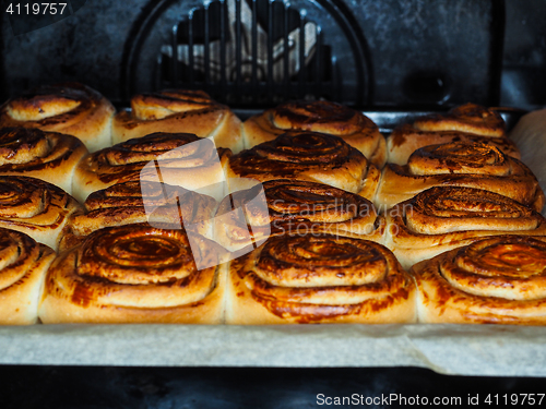 Image of Closeup of fresh baked cinnamon buns after baking in oven, with 