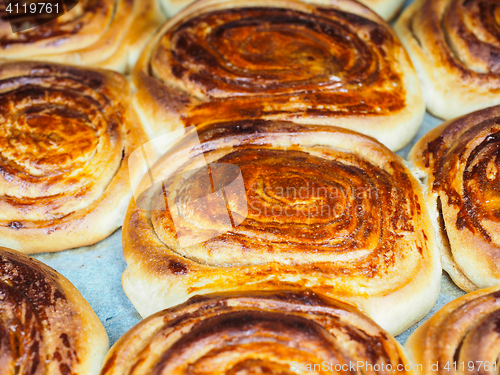 Image of Closeup of fresh baked cinnamon buns after baking in oven, with 