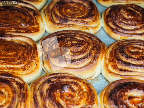 Image of Closeup of fresh baked cinnamon buns after baking in oven, with 