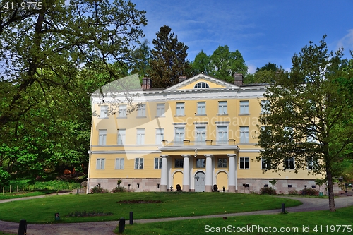 Image of Yellow old manor with a garden