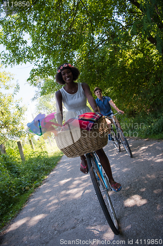 Image of Young  couple having joyful bike ride in nature