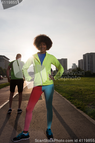 Image of Portrait of sporty young african american woman running outdoors