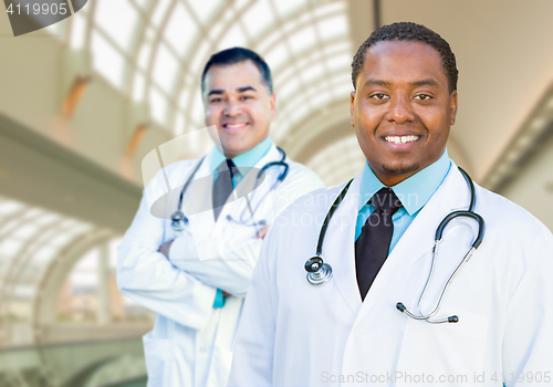 Image of African American and Caucasian Male Doctors Inside Hospital