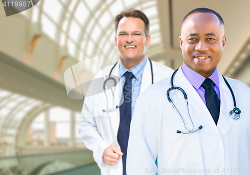 Image of African American and Caucasian Male Doctors Inside Hospital