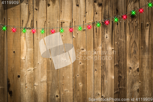 Image of Lustrous Wooden Background with Green and Red Christmas Lights