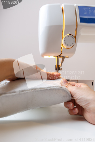 Image of Sewing machine with girl close-up