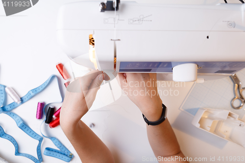 Image of Woman sets up sewing machine